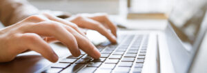 hands typing on a keyboard