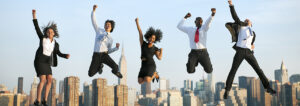 5 professionals jumping up in the air with joy