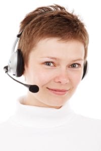 Smiling customer service woman wearing a headphone.