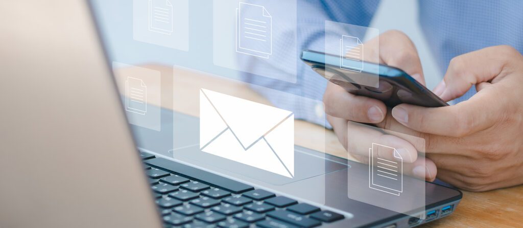 Person at a computer sending an email newsletter.